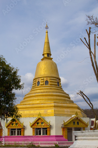 The golden pagoda over scenic blue sky background at Wat Klong reua. Phitsanulok, Thailand.