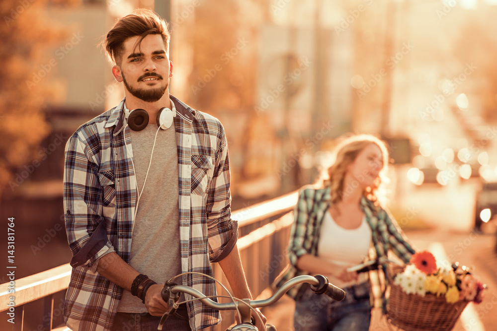 Happy young couple going for a bike ride Happy young couple going for a bike ride