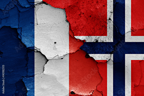 flags of France and Norway painted on cracked wall