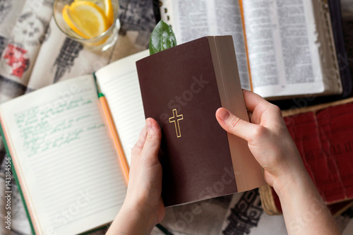 Girl holding a Bible. Сoncept for faith, spirituality and religion. Young woman reading a Bible.