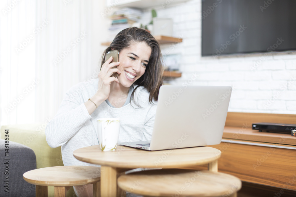 Young beautiful woman sitting on the floor working on laptop. Morning scene Young beautiful woman sitting on the floor working on laptop. Morning scene