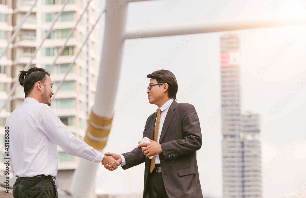 Business handshake. Handshake of two business men closing a deal city blackground Business handshake. Handshake of two business men closing a deal city blackground