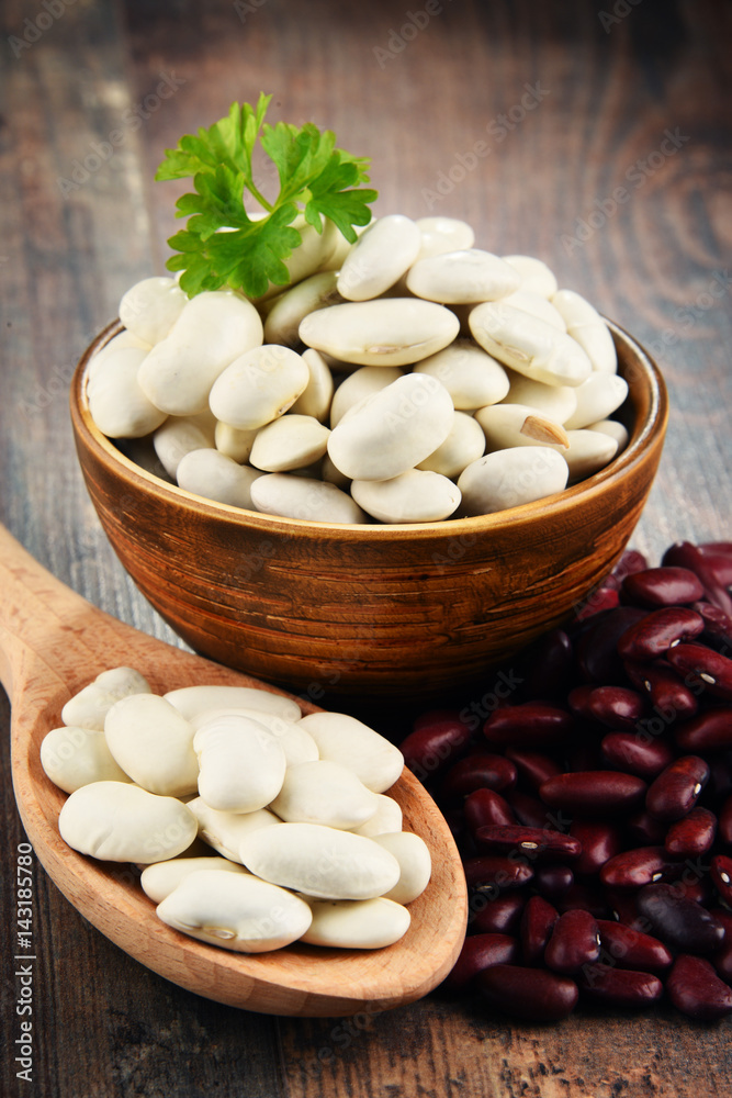 Composition with bowl of beans on wooden table Composition with bowl of beans on wooden table