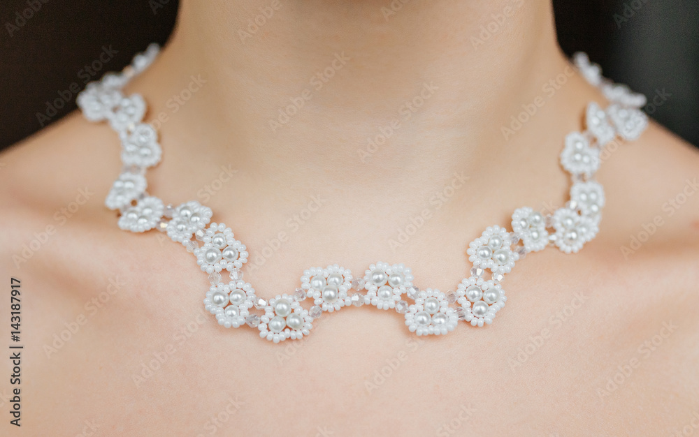 Jewelry concept. Closeup portrait of a wedding necklace on female neck