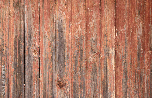 Old shabby wooden wall painted red