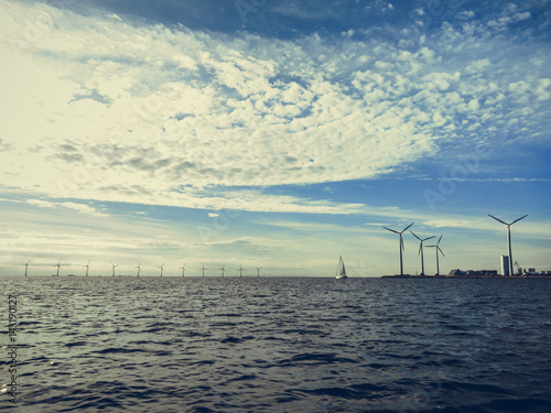 Wind turbines power generator farm along coast sea