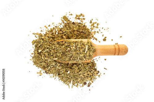 Yerba mate with a wooden spoon on isolate a white background