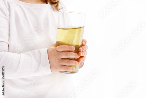 Little girl keeping glass of aqua