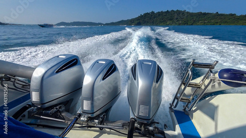 Three powerful engines mounted on the speedboat. Andaman Sea, Thailand.