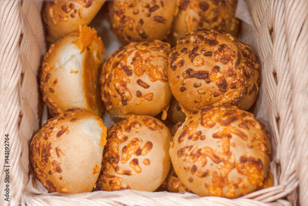 Closeup macro shot of round fresh cheese buns in basket with white paper Closeup macro shot of round fresh cheese buns in basket with white paper