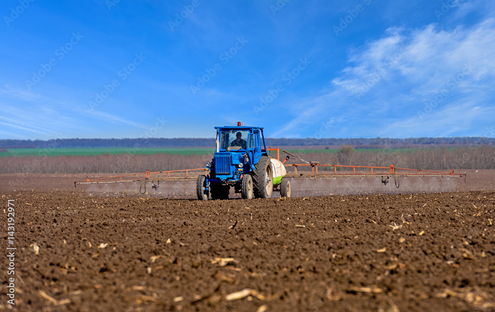 Naklejka premium Farm machinery spraying insecticide to field.