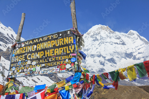 ANNAPURNA, NEPAL – APRIL 14, 2016 : Himalaya Annapurna South mountain peak with Annapurna base camp sign, there is very famous trekking destination in Nepal. photo