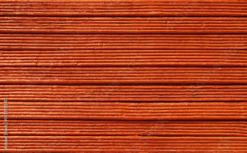 Wooden red trims background. Wooden bars  painted in red.