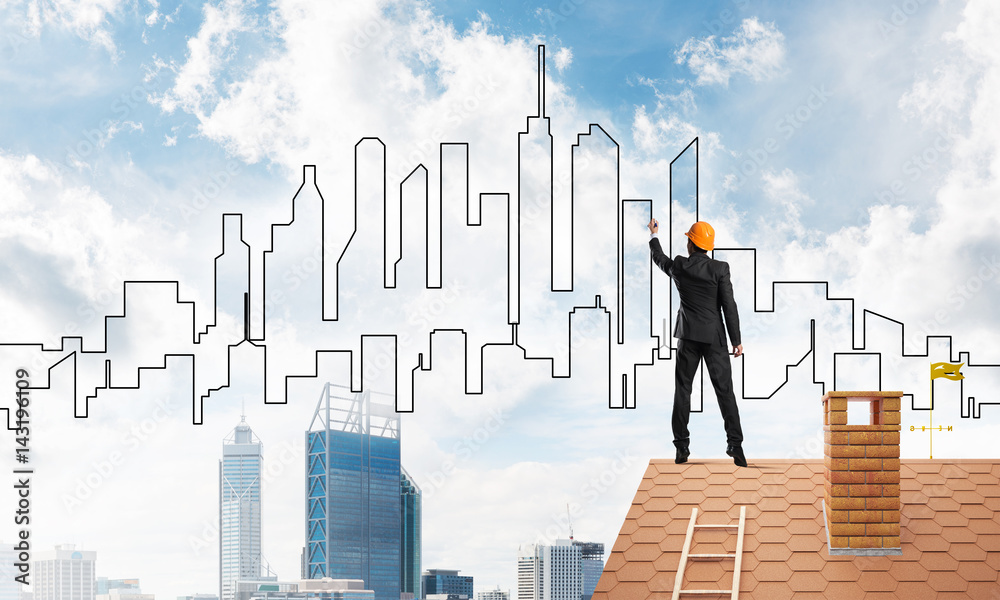 Man architect draw silhouette of modern city on blue sky. Mixed media Man architect draw silhouette of modern city on blue sky. Mixed media