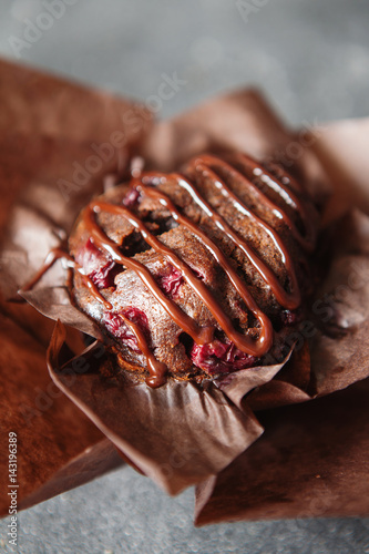 Dark chocolate muffin with cherry and sauce photo