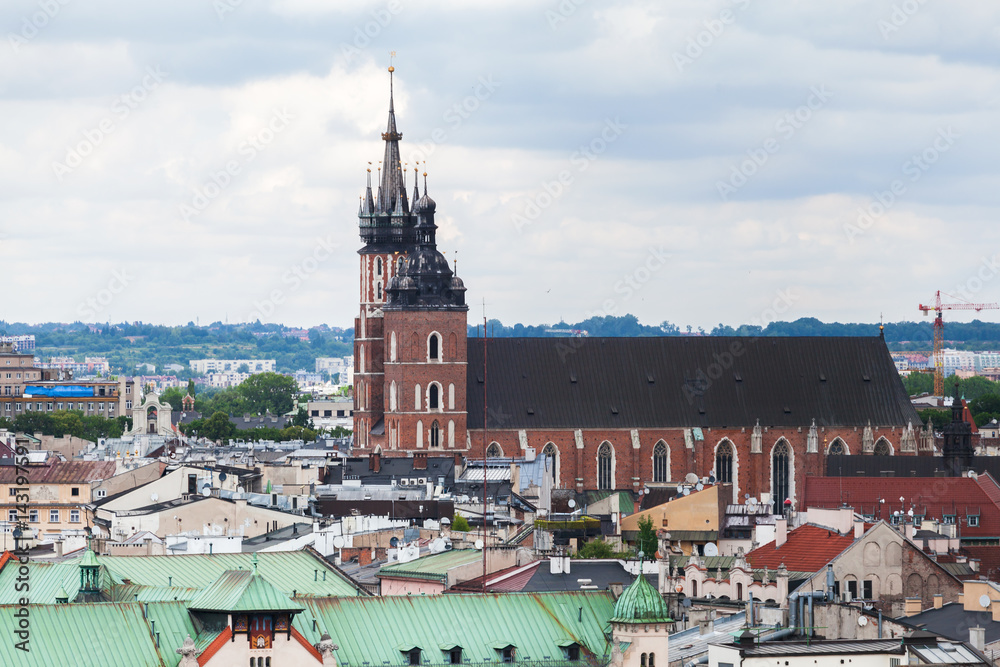 Naklejka premium Aerial view of the Church of St. Mary in Krakow. Basilica Mariacka. Dramatic sky. Krakow. Poland. Panorama of city