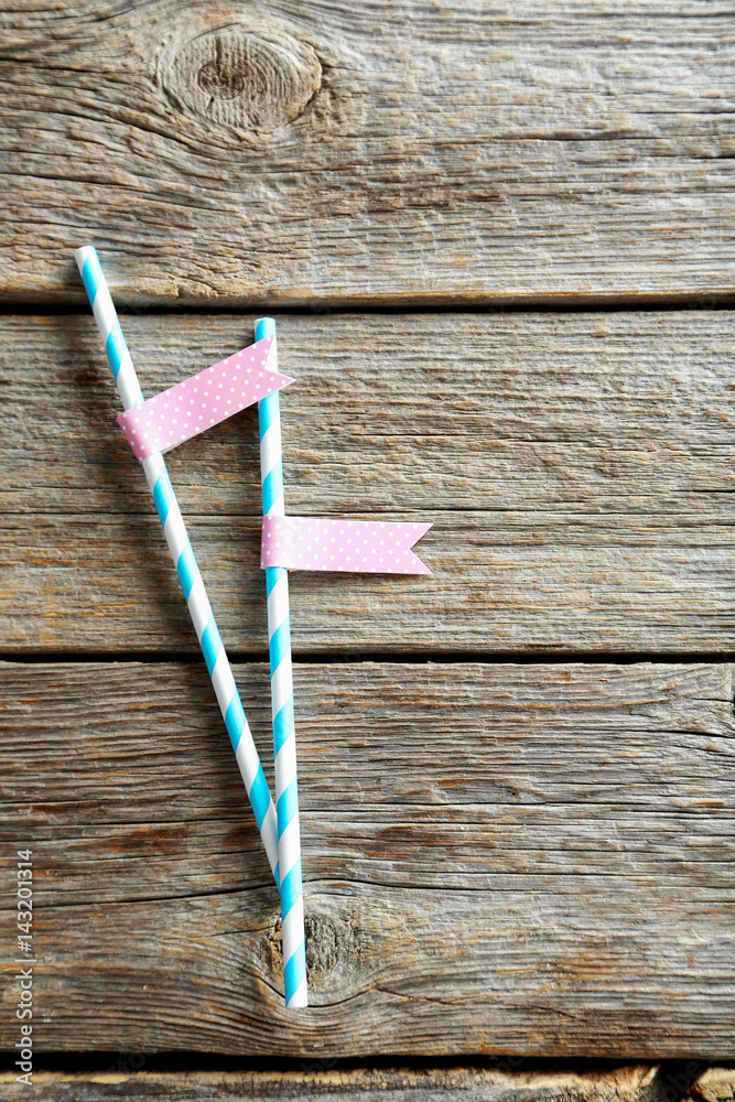Striped drink straws on grey wooden table Striped drink straws on grey wooden table