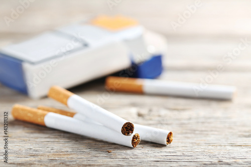 Tobacco cigarettes on a grey wooden table