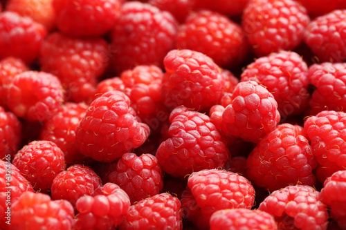 Ripe and sweet red raspberries background