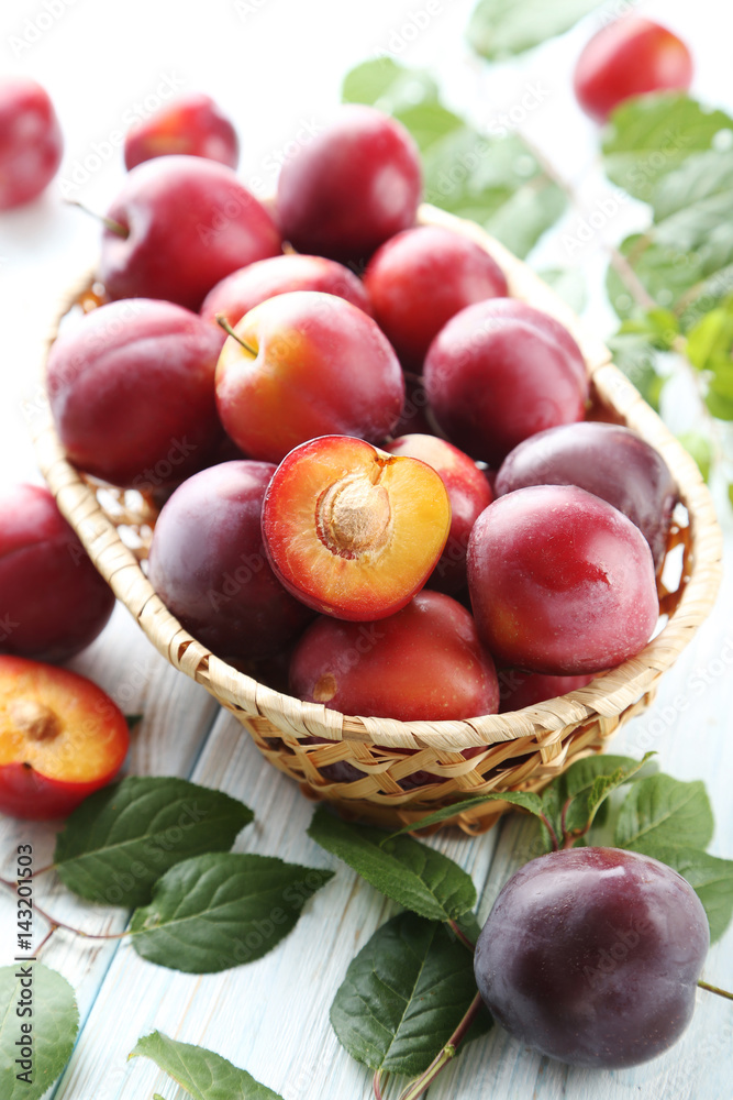 Fresh plums on a white wooden table Fresh plums on a white wooden table