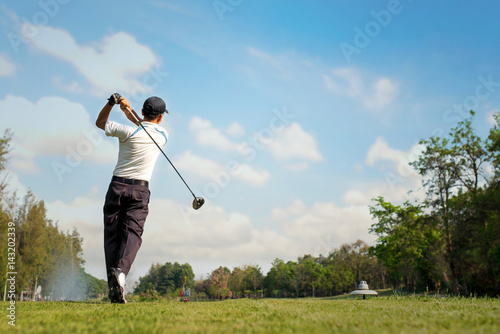 Golfer Hitting Golf Shot with Club on Beautiful Golf Course on Vacation