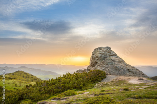 The rock on the sunrise background.