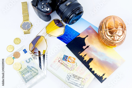 Top view. Objects of a traveler isolated on white background: envelope, souvenir, camera, cash, sunglasses, watch, photos of Turkey and the sea and passport with visas