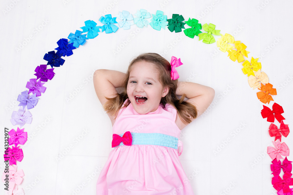 Fototapeta premium Little girl with colorful bow. Hair accessory