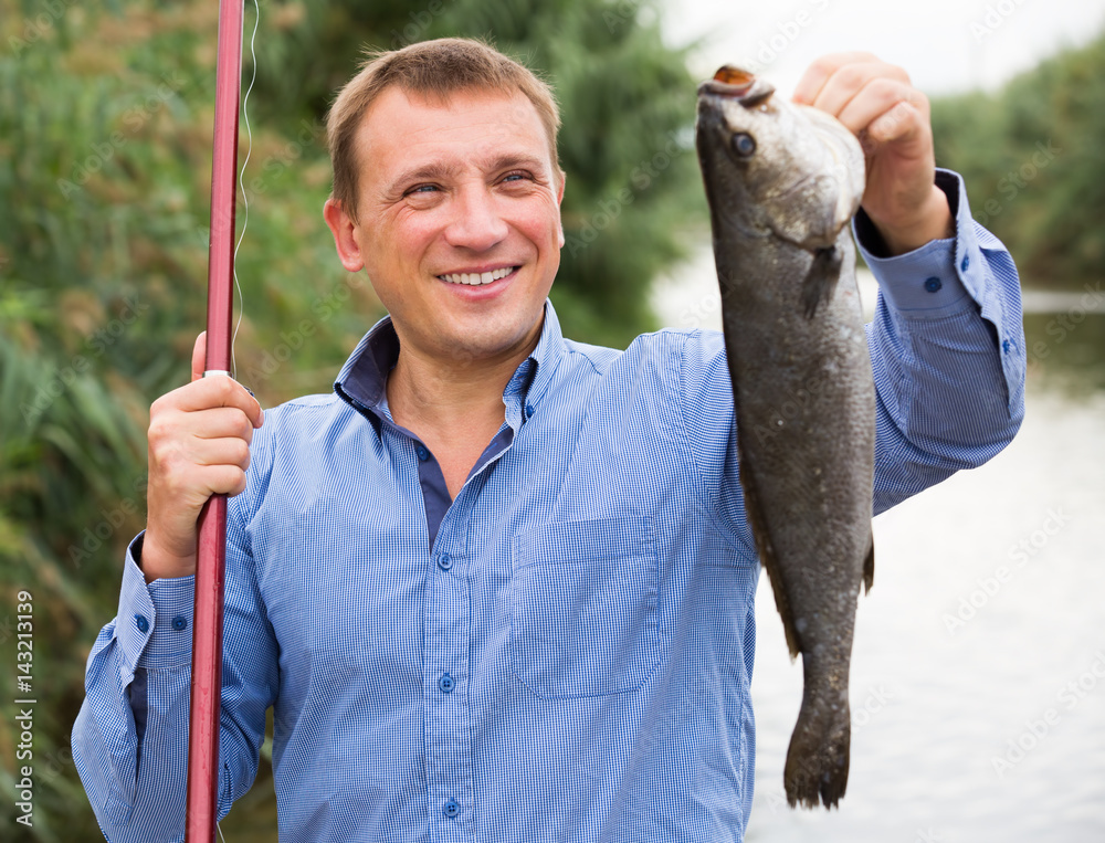 Man holding fish after fishing Stock Photo