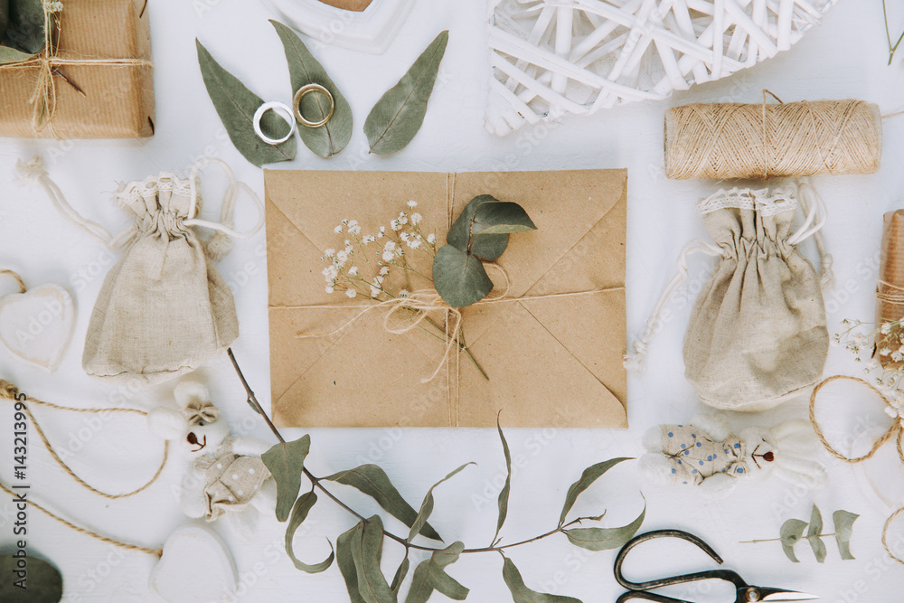 Craft envelope with decorations. Love or wedding letter invitation. Flat lay. Top view Craft envelope with decorations. Love or wedding letter invitation. Flat lay. Top view