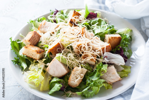 Fototapeta Caesar salad in white plate