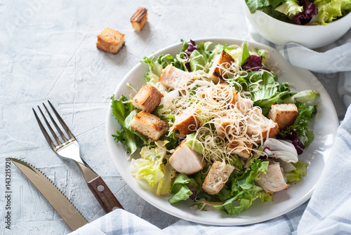 Fototapeta Caesar salad in white plate