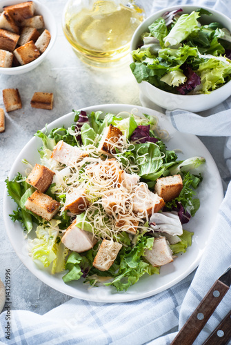Fototapeta Caesar salad in white plate