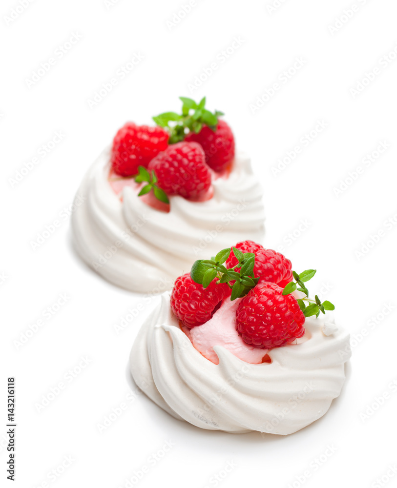 Mini Pavlova meringue nests with berries and thyme on isolated on white Mini Pavlova meringue nests with berries and thyme on isolated on white