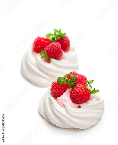 Mini Pavlova meringue nests with berries and thyme on isolated on white