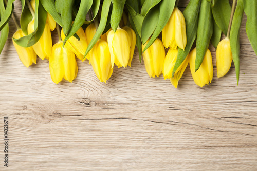 tulips on a rustic wood background