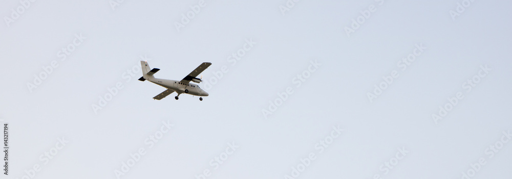 Private airplane flying, isolated on a bright blue sky Private airplane flying, isolated on a bright blue sky