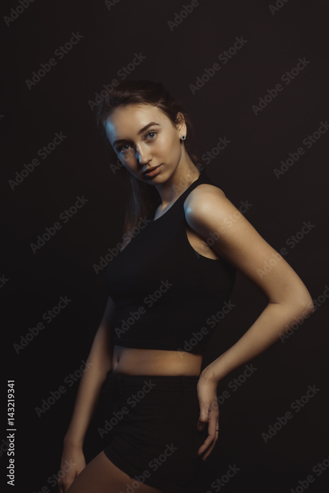 Beautiful young sexy model in dark studio with blue light Beautiful young sexy model in dark studio with blue light