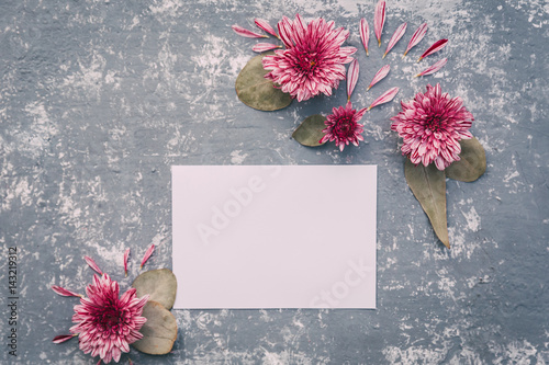  Paper blank and pink flowers on white background. Mockup with flowers. Flat lay, top view photo