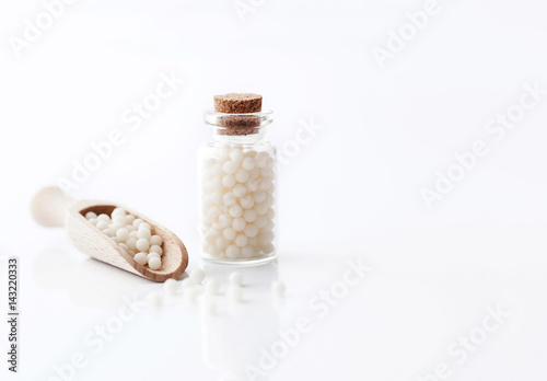 homeopathic pills shot against a white background. alternative medicine