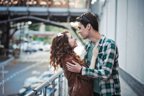 Beautiful young couple hugging on the street