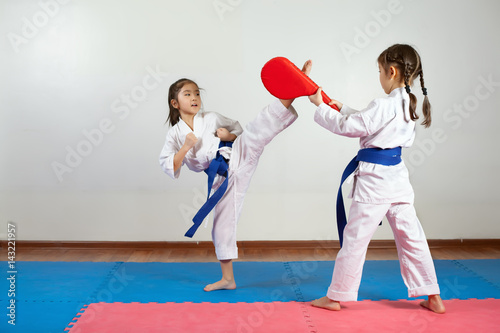 Two little girls demonstrate martial arts working together