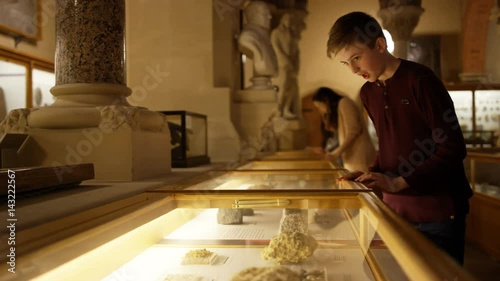  Mother & son in natural history museum looking into glass display case