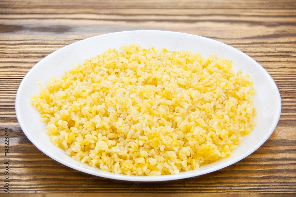 Delicious home made pilaw from wheat on plate Delicious home made pilaw from wheat on plate