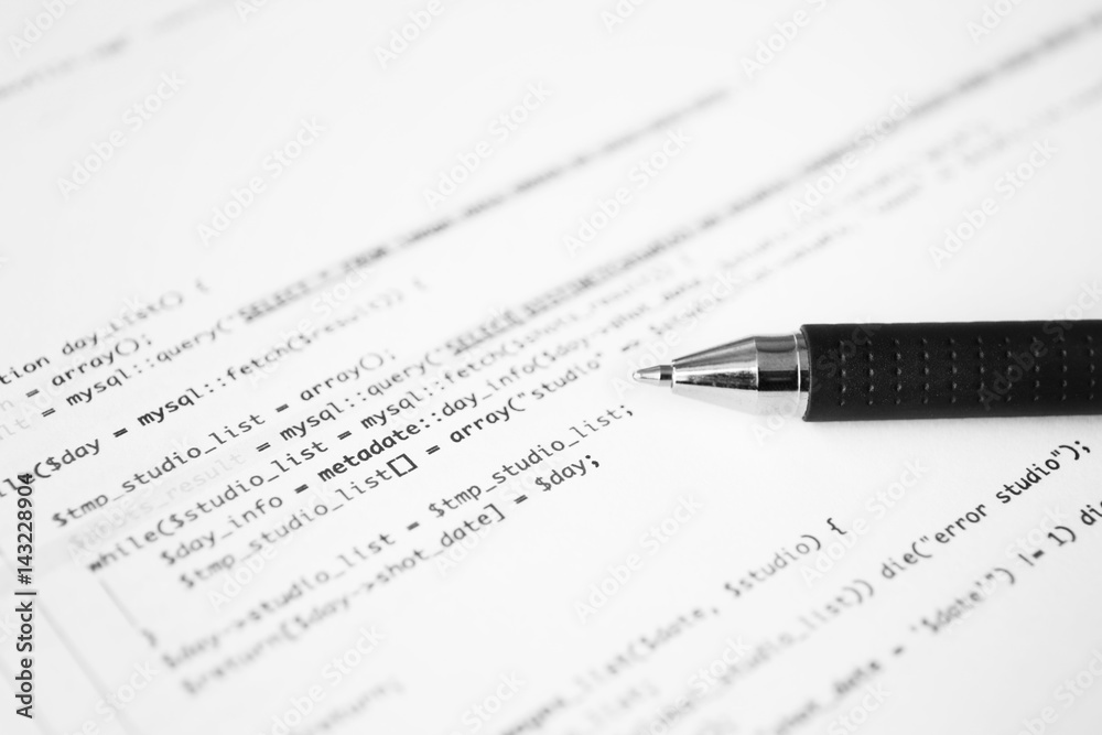 Script code on paper and pen, closeup. Software development concept Script code on paper and pen, closeup. Software development concept
