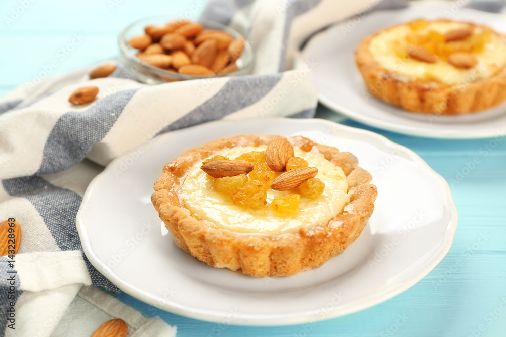 Plates with delicious crispy tarts on wooden background Plates with delicious crispy tarts on wooden background