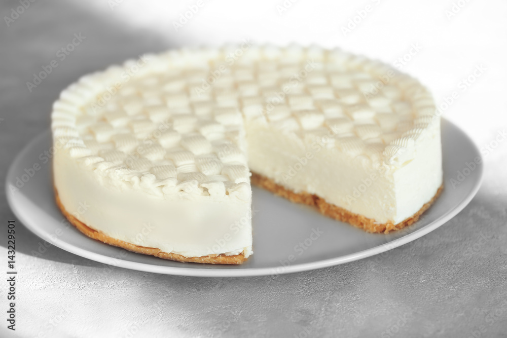 Delicious plain cheesecake on grey table
