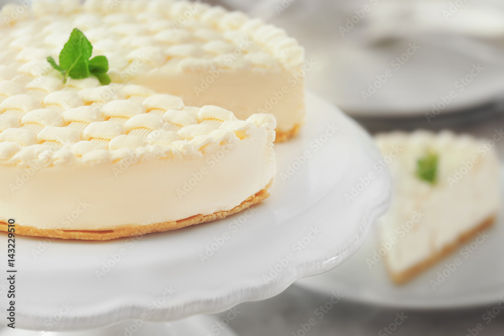 Delicious plain cheesecake on white stand