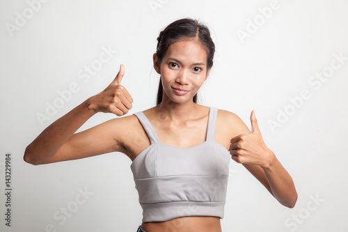 Young Asian woman show two thumbs up.