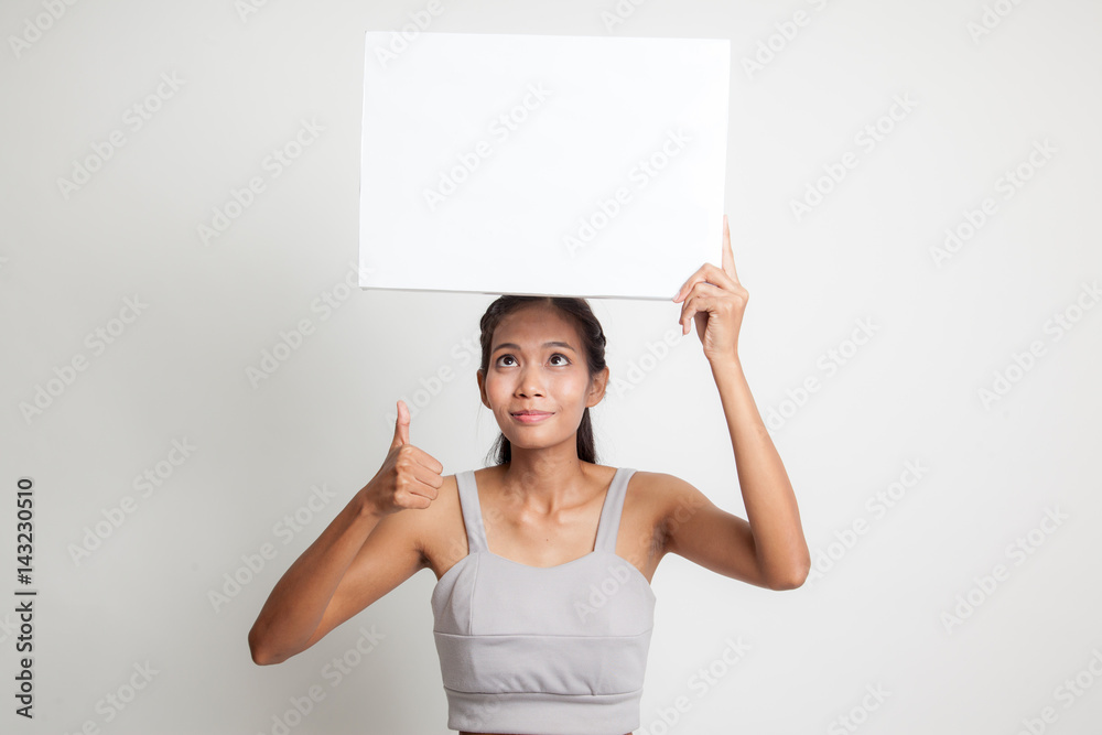 Young Asian woman show thumbs up with white blank sign. Young Asian woman show thumbs up with white blank sign.